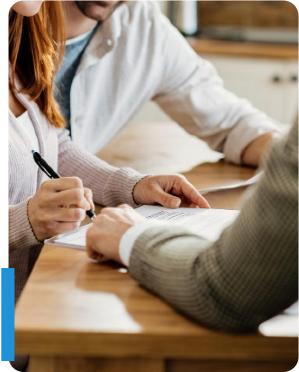 Couple meeting with broker and signing contract paperwork for selling an independent insurance agency.