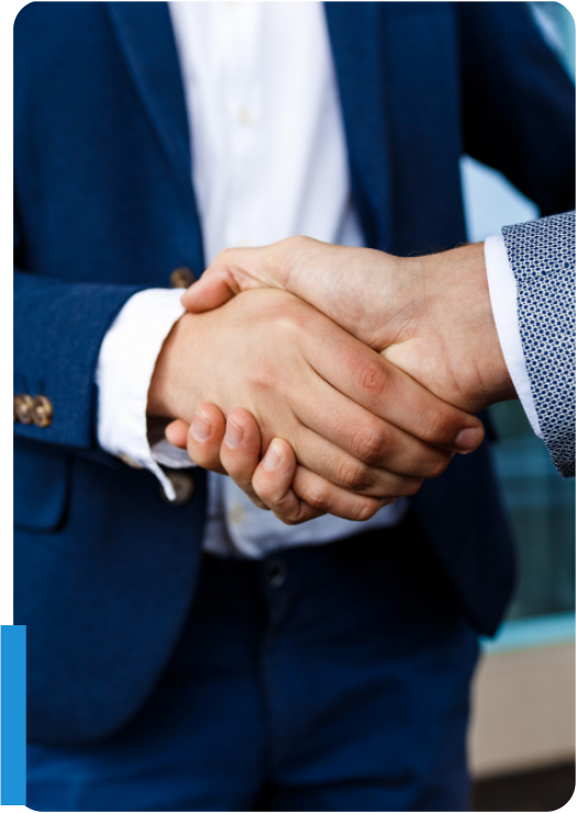 Business professionals shaking hands to finalize an insurance agency merger and acquisition deal.